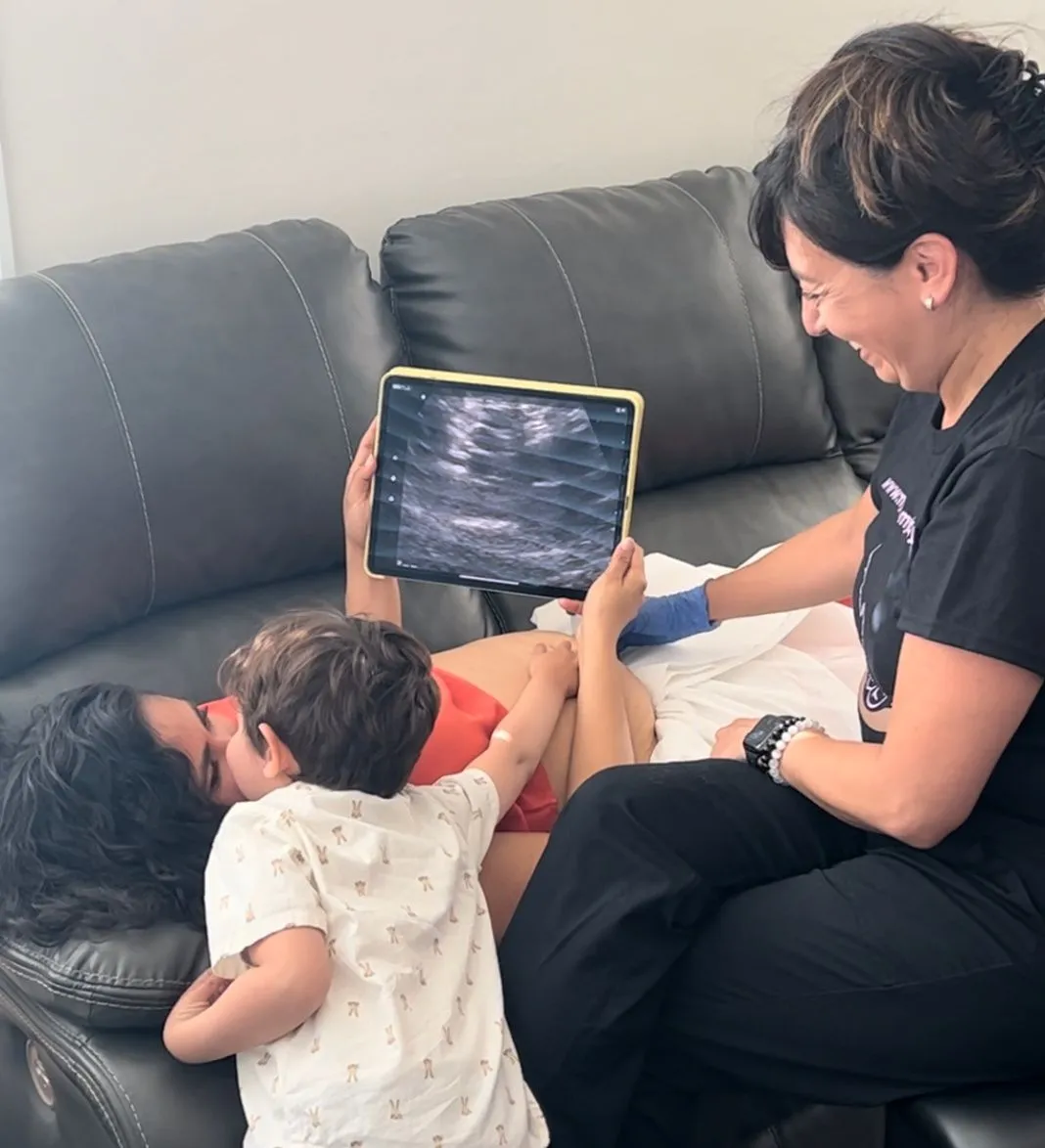 Family viewing an at-home sonogram together