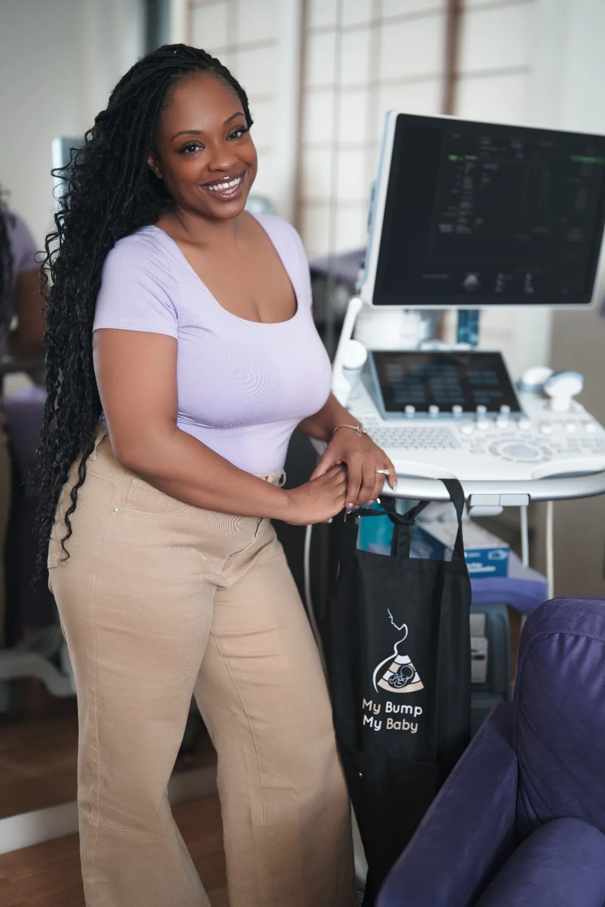 Charlotte Williams standing beside an ultrasound system